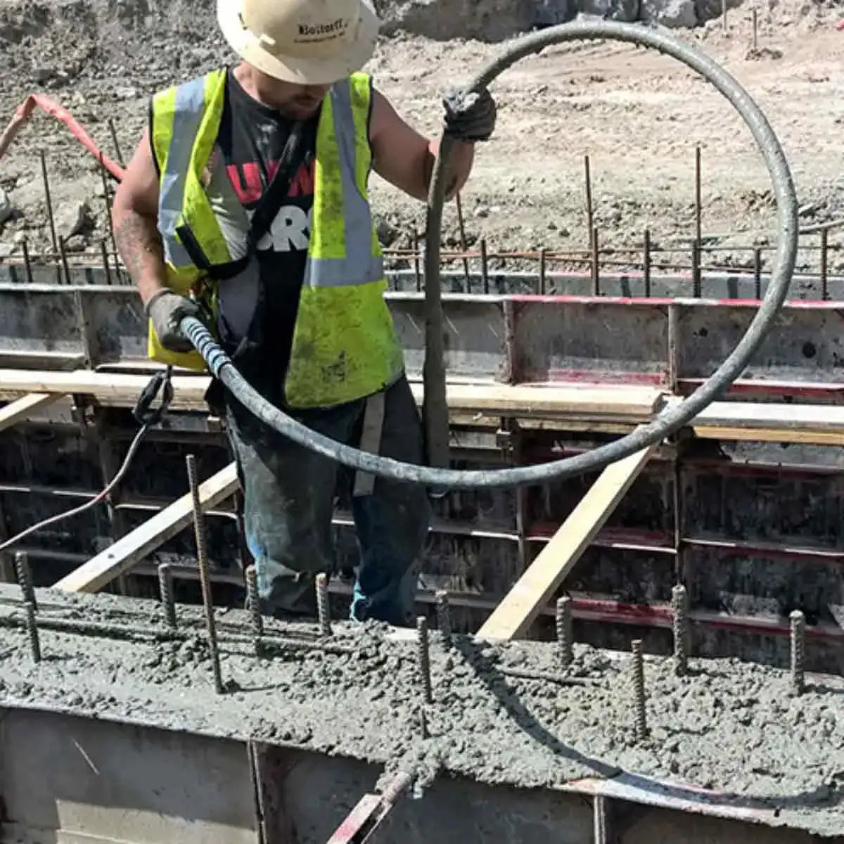 Wacker Neuson M1500 concrete vibrator in use on wall form