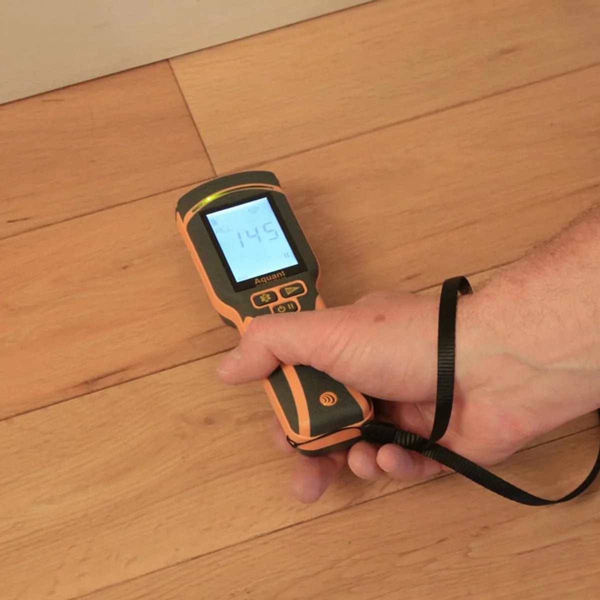 Protimeter Aquant moisture meter testing on hardwood flooring