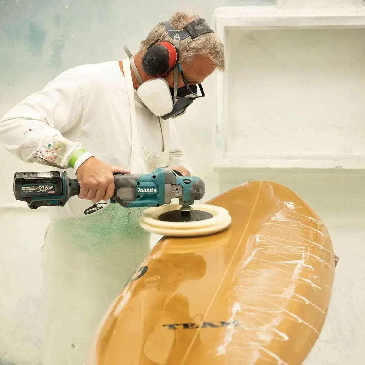 Makita 40V max XGT Brushless Cordless 7" Polisher in use on a surf board