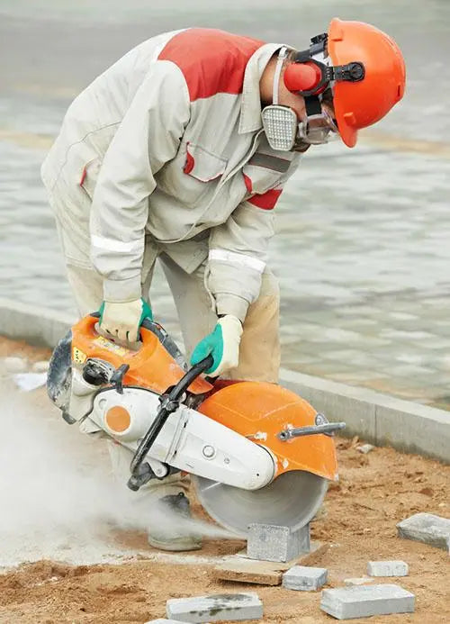 construction worker sawing brick